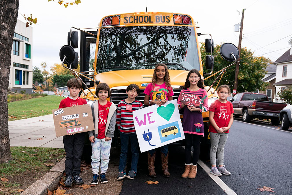 Kids with electric school bus