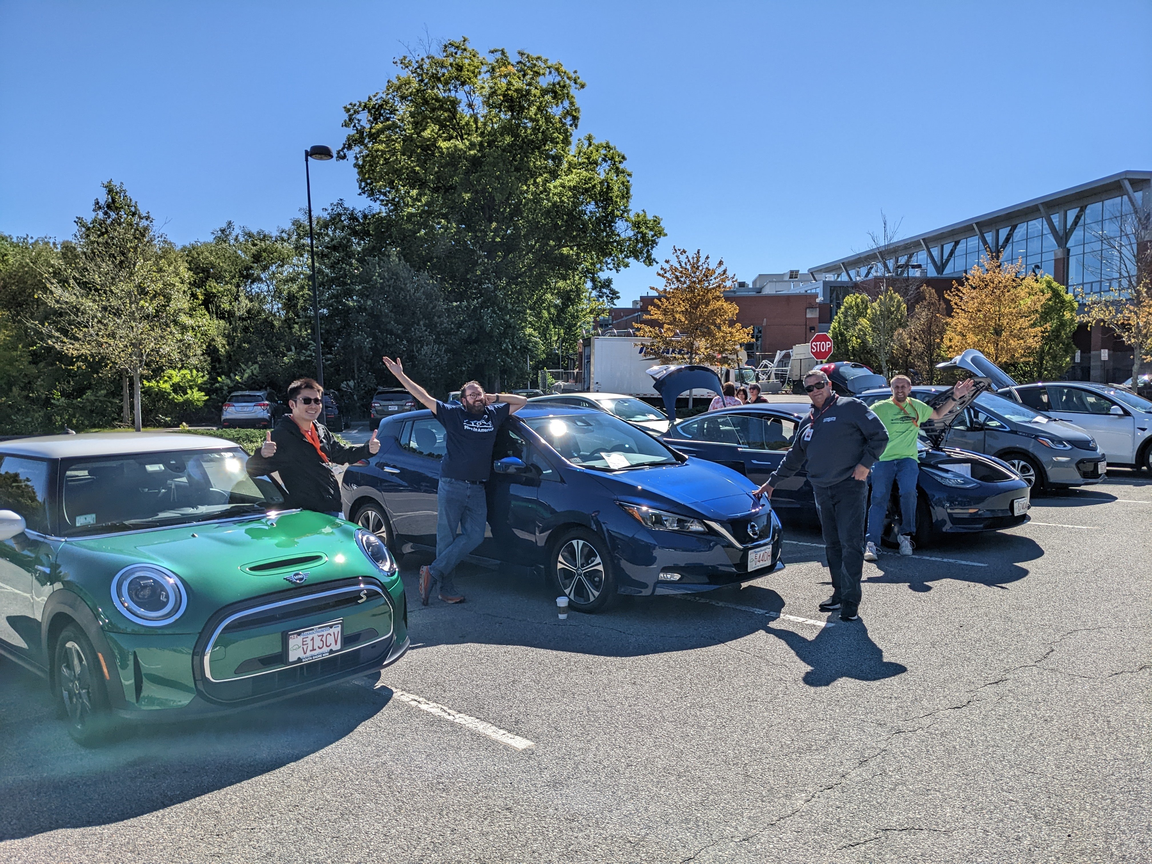 NDEW 2022 QARI Quincy EV Showcase 9.24.22 Green MINI Cooper blue Nissan LEAF black Tesla row of cars people pointing great horizontal picture