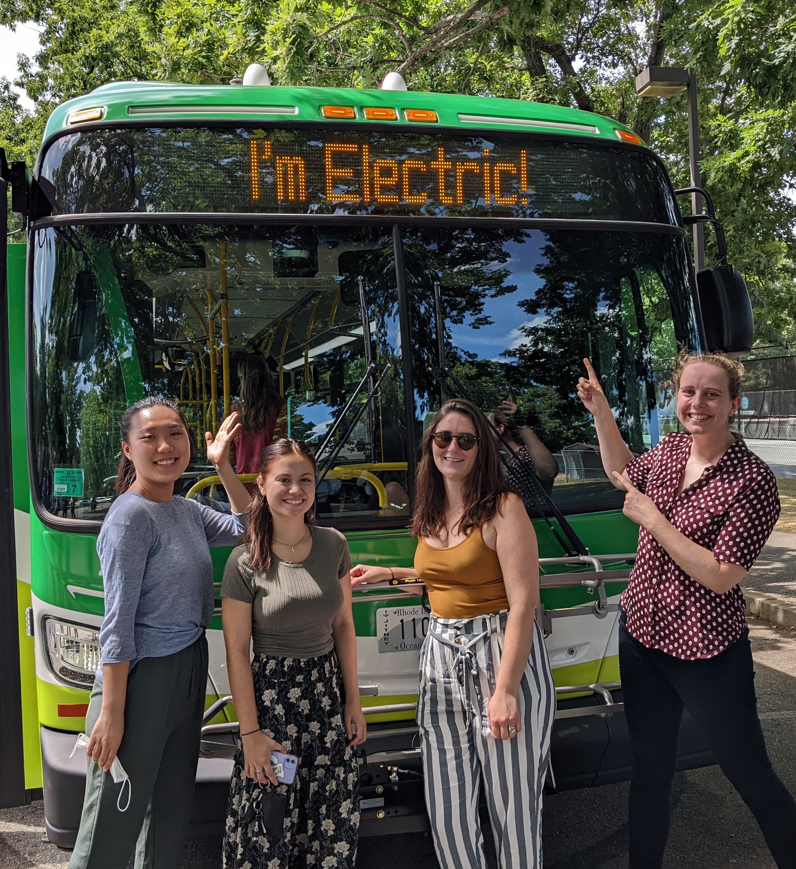 RIPTA electric transit bus ribbon cutting 8.9.22 Kelly Eden Devan Anna pointing at _I_m Electric_ front of bus