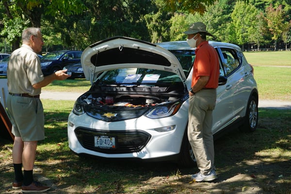 Goddard Park NDEW_2021_DG, white Chevy Bolt, electric vehicle, people talking, hood up