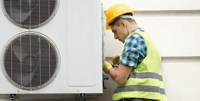 work development, man fixes heatpump